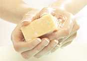 	Close-up of a worker wash her hands with soap and water